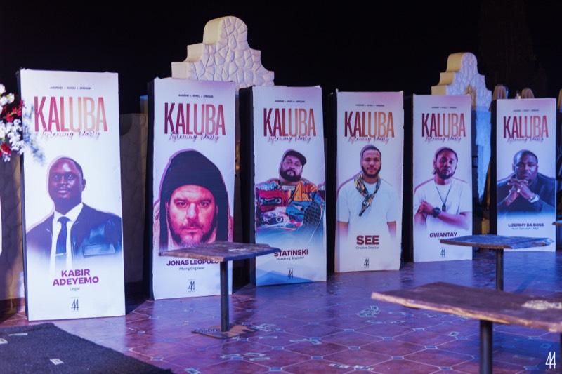 Campaign standees for the credited team, lined up on stage.