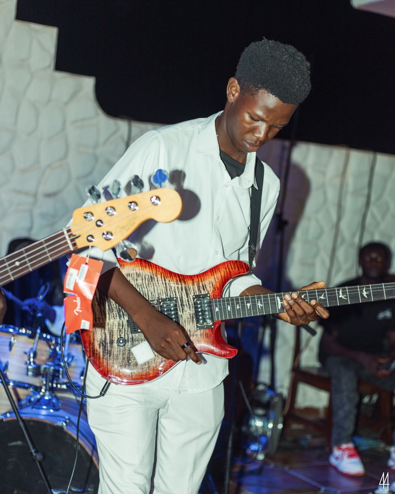 A bassist playing on stage.